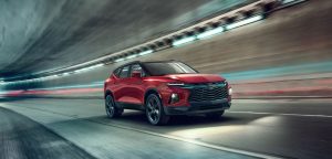 A red 2022 Chevrolet Blazer driving fast in a tunnel.