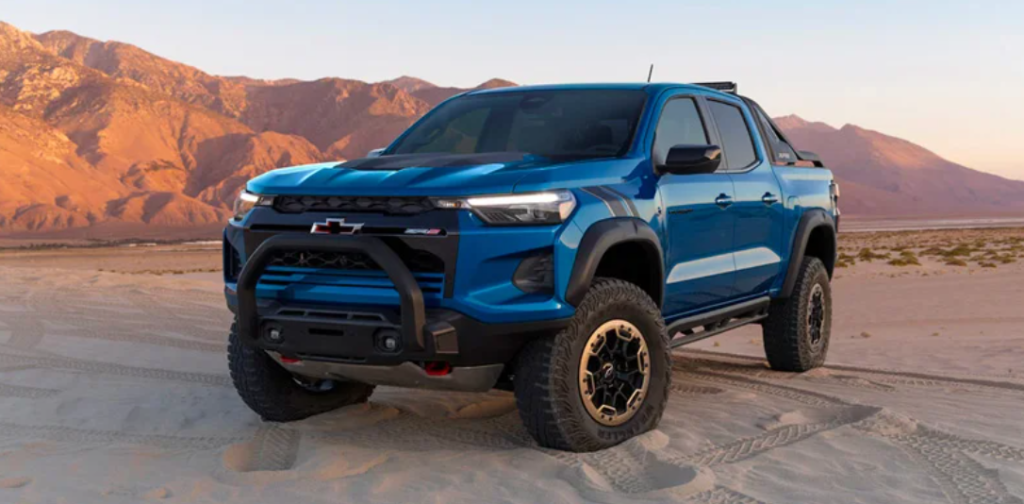 A blue 2023 Chevrolet Colorado parked on a desert.