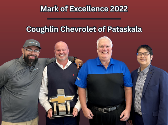 Employees from Coughlin Chevrolet of Pataskala posing for a photo with their Mark of Excellence 2022 award.